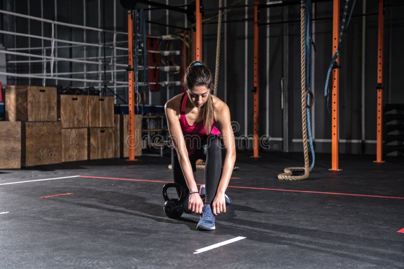 Athletic girl ready to start exercises with a kettlebell at the gym royalty free stock images Athletic girl ready to start exercises with a kettlebell at the gym royalty free stock images
