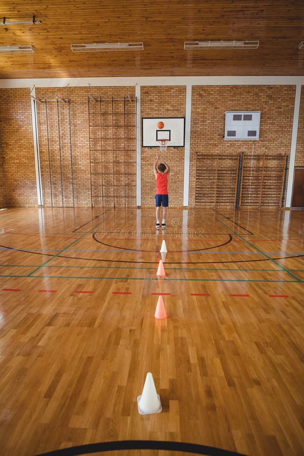 Determined high school boy playing basketball stock images