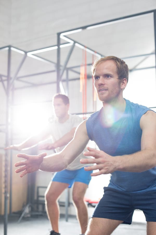 Determined men exercising at crossfit gym stock photo Determined men exercising at crossfit gym stock photo
