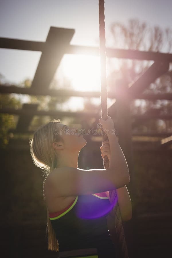 Determined Woman Climbing Rope during Obstacle Course Stock Photo ...