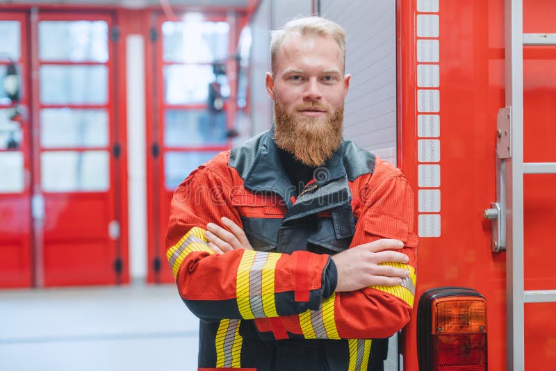 Determined young fire fighter in front of a fire truck royalty free stock images