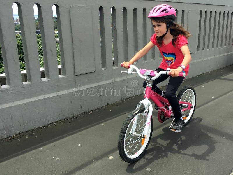 Determined young girl rides a bike royalty free stock image