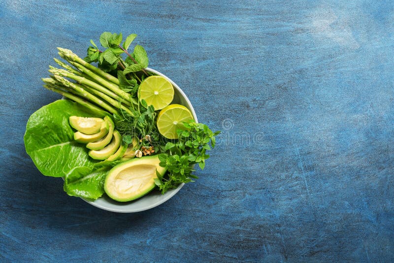 Detox Buddha bowl with avocado, asparagus, micro greens, lime, lettuce, basil and mint.Dietary food. Blue rustic background, top v stock photos Detox Buddha bowl with avocado, asparagus, micro greens, lime, lettuce, basil and mint.Dietary food. Blue rustic background, top v stock photos