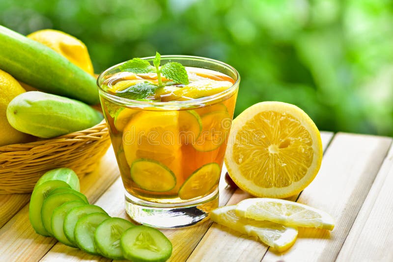 Detox water drink with honey lemon and cucumber in glass