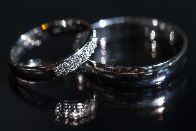 Wedding day details - two lovely golden wedding rings awaiting their moment, with some nice reflections. Wedding day details - two lovely golden wedding rings awaiting their moment, with some nice reflections