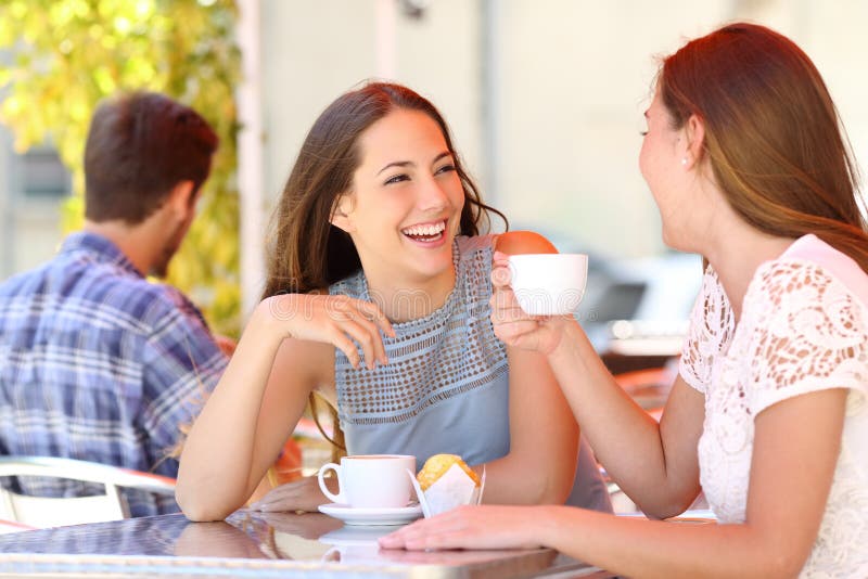 Deux amis ou soeurs parlant prenant une conversation dans une barre photos libres de droits