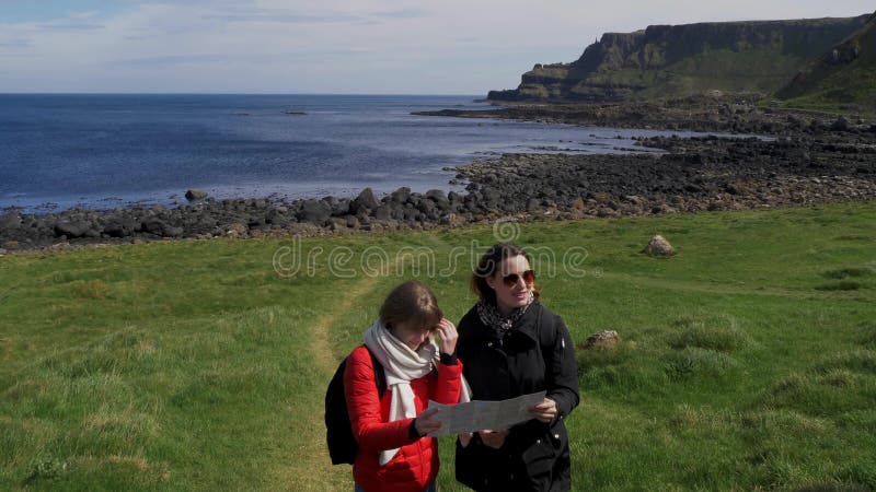 Deux filles voyagent à la chaussée de Giants en Irlande du Nord