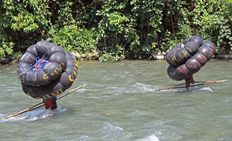 Deux hommes portent le tube, Bukit Lawang photographie stock Deux hommes portent le tube, Bukit Lawang photographie stock