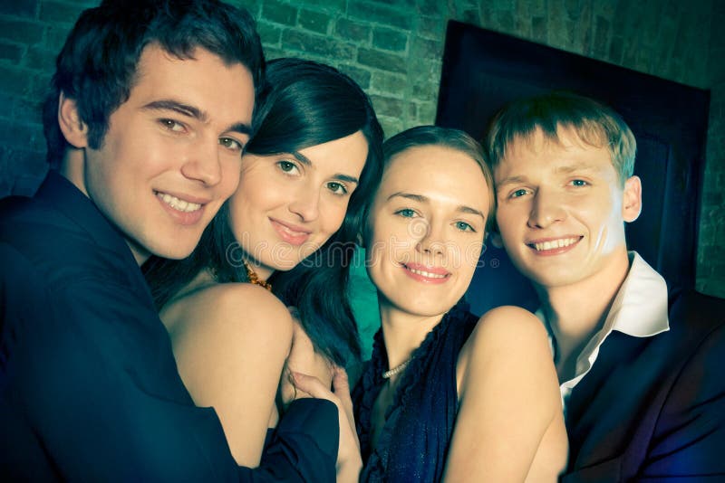 Two young attractive smiling couples or friends at a Party. Two young attractive smiling couples or friends at a Party
