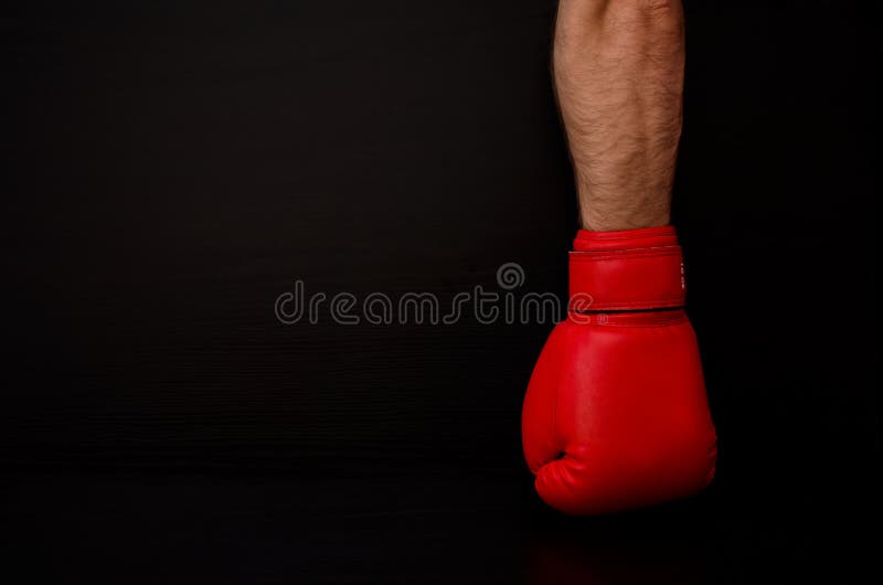 Deux mains dans les gants de boxe rouges dans le côté du cadre sur un fond noir, Â vident l'espace images libres de droits Deux mains dans les gants de boxe rouges dans le côté du cadre sur un fond noir, Â vident l'espace images libres de droits