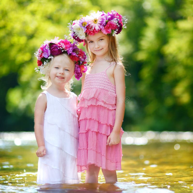 Deux petites soeurs utilisant des couronnes de fleurs photos libres de droits Deux petites soeurs utilisant des couronnes de fleurs photos libres de droits