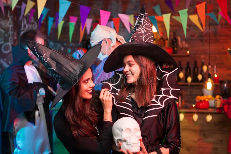 Two witches having a good time together at halloween party. Witches celebrating halloween. Two witches having a good time together at halloween party. Witches celebrating halloween.