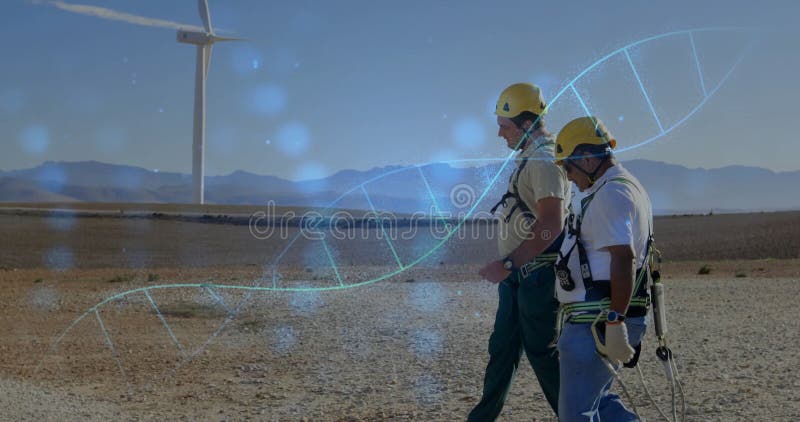 Deux techniciens de site marchant près d'une éolienne sur un parc éolien superposant double hélice graphique pour l'énergie clips vidéos