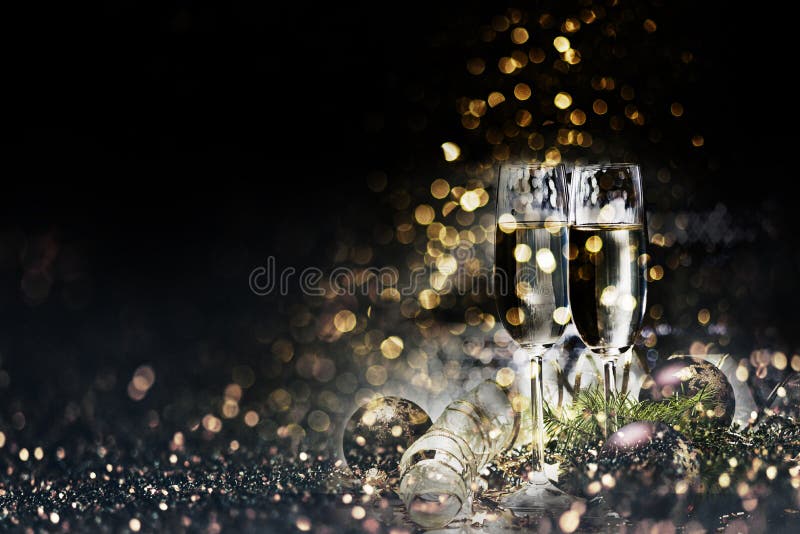 Deux verres de champagne et décoration de noël sur fond de bouquins dorés foncés photographie stock libre de droits Deux verres de champagne et décoration de noël sur fond de bouquins dorés foncés photographie stock libre de droits