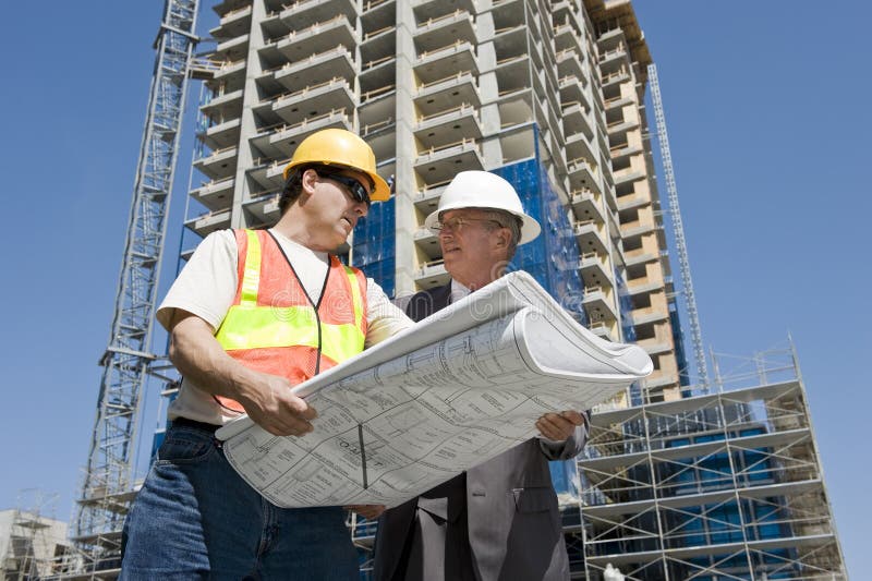 Bauherren und Auftragnehmer diskutieren Fortschritte auf hirise-Bau-Projekt auf der Baustelle.