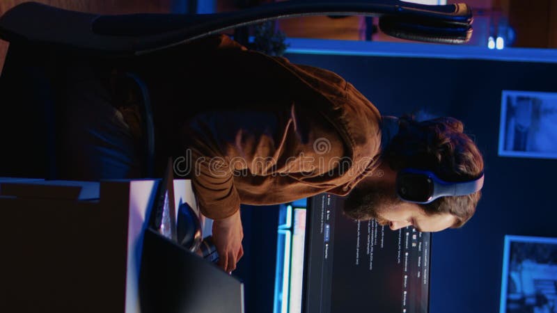 Developer typing code in home office, using Java programming language to develop software application. It professional using multimonitor PC setup and laptop to finish tasks, camera B. Developer programming code video