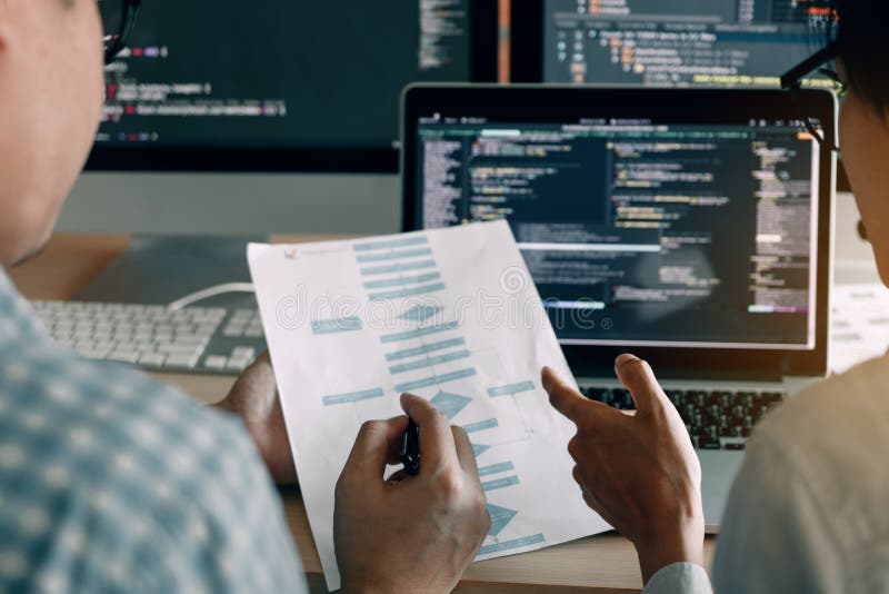 Developing programming and coding technologies working in a software engineers developing applications together in office stock image