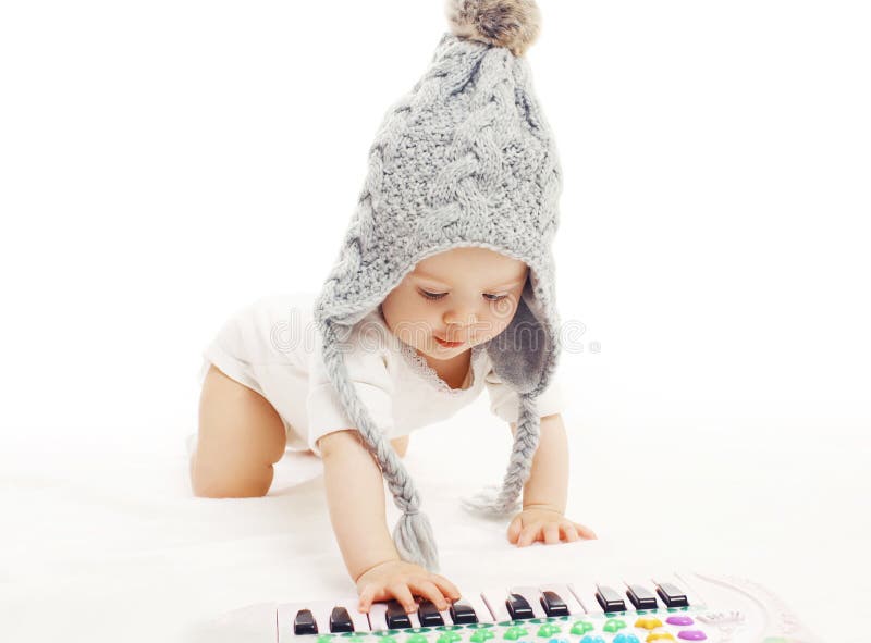 Development child, baby in knitted hat playing stock photos Development child, baby in knitted hat playing stock photos