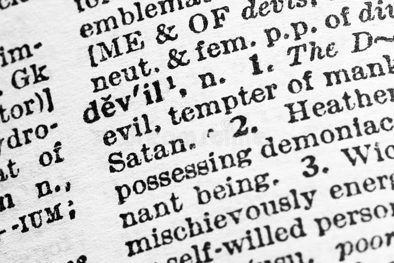 Devil - Closeup macro of English dictionary page with word devil concept stock photography