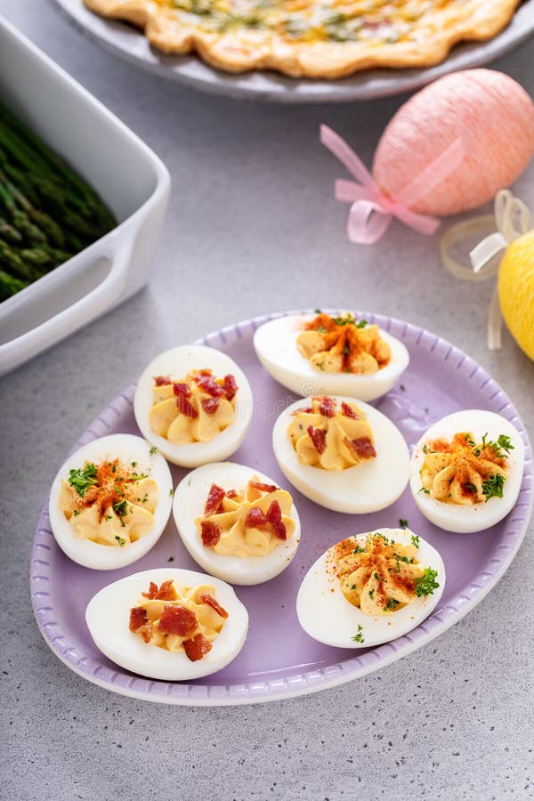 Deviled eggs with bacon and smoked paprika stock photo