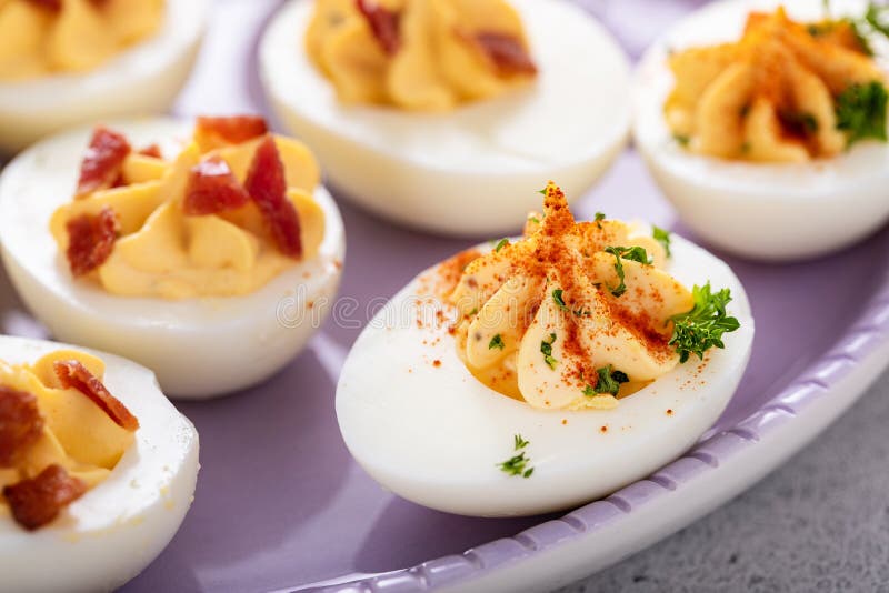 Deviled eggs with bacon and smoked paprika stock images