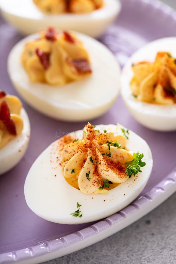 Deviled eggs with bacon and smoked paprika stock photography