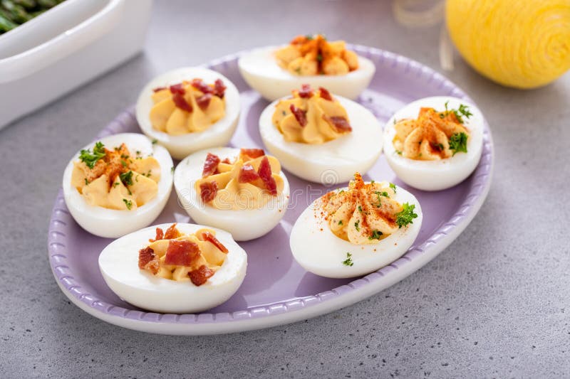 Deviled eggs with bacon and smoked paprika stock photography