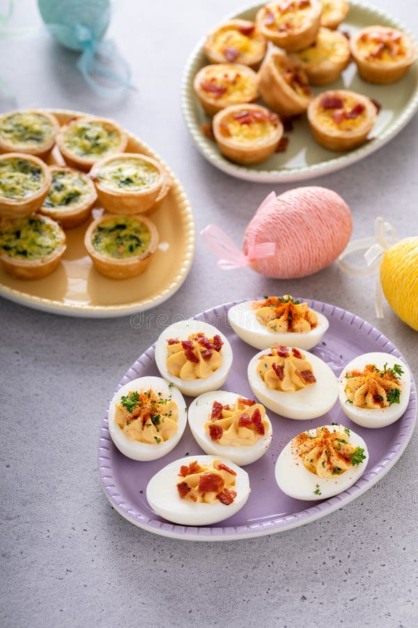 Deviled eggs and mini quiches, appetizers for Easter royalty free stock photos