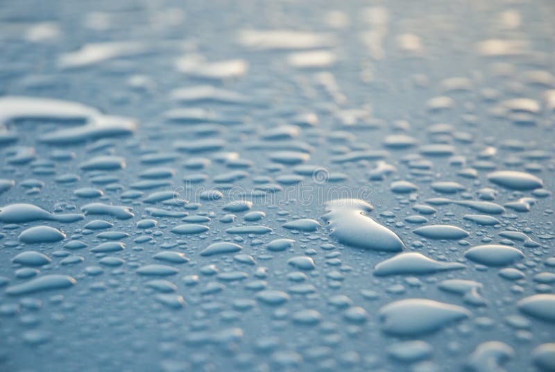 Dew drops on blue metallic surface