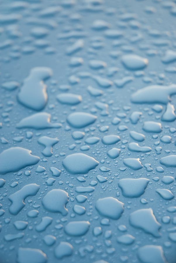 Dew drops on blue metallic surface