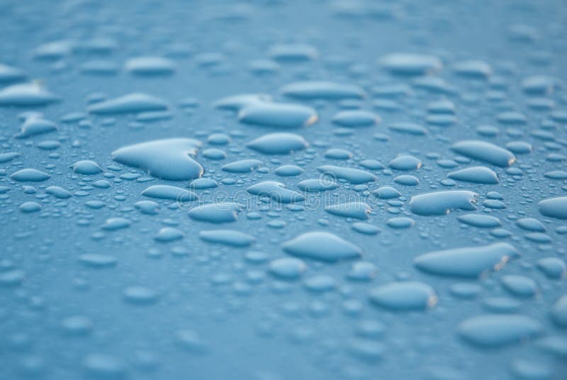 Dew drops on blue metallic surface