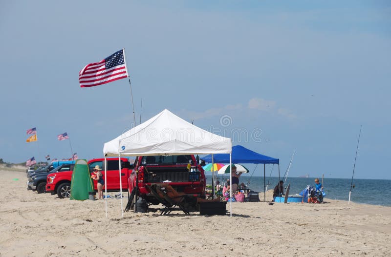 The View Ogf White Tent with Trucks on the Drive in and Surf Fishing The View Ogf White Tent with Trucks on the Drive in and Surf Fishing