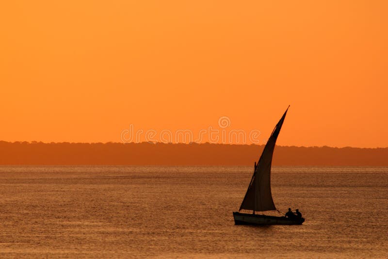 Traditional sail boat called a dhow at sunset, Vilanculos coastal sanctuary, Mozambique. Traditional sail boat called a dhow at sunset, Vilanculos coastal sanctuary, Mozambique