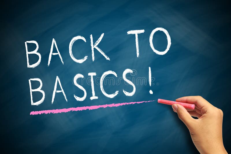 Hand with red chalk writing Back To Basics on chalkboard. Hand with red chalk writing Back To Basics on chalkboard.