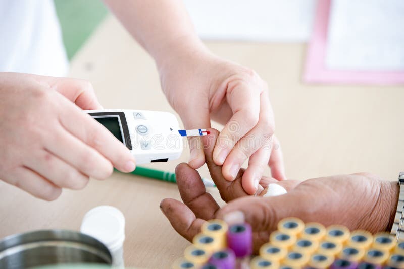 Doctor testing blood in diabetes patient, fasting blood sugar. Doctor testing blood in diabetes patient, fasting blood sugar