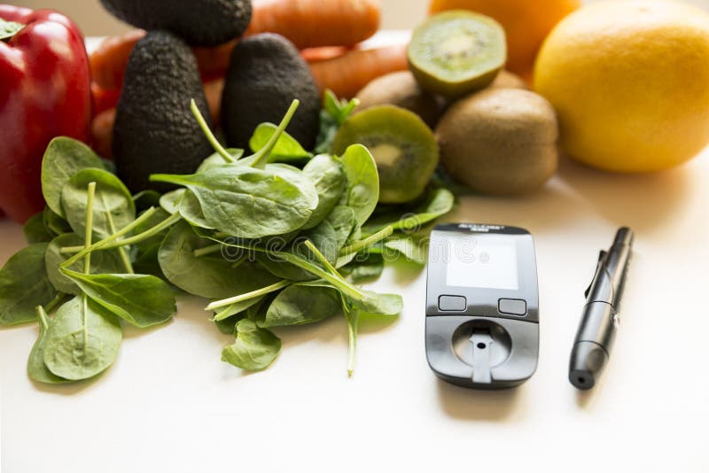 Diabetes monitor, diet and healthy food eating nutritional concept with clean fruits and vegetables with diabetic measuring tool royalty free stock photos Diabetes monitor, diet and healthy food eating nutritional concept with clean fruits and vegetables with diabetic measuring tool royalty free stock photos