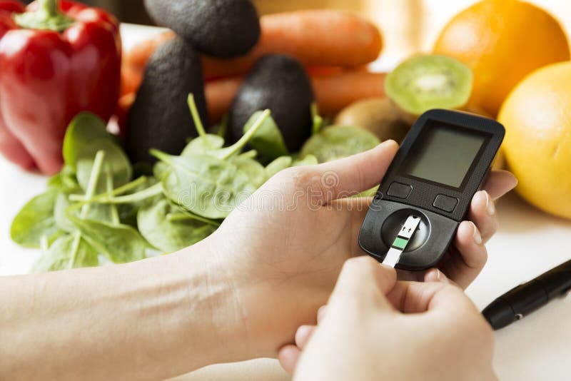 Diabetes monitor, diet and healthy food eating nutritional concept with clean fruits and vegetables with diabetic measuring tool
