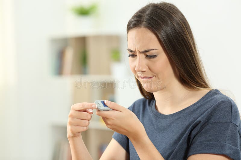 Diabetisk flicka som kontrollerar nivån för blodsocker royaltyfria foton Diabetisk flicka som kontrollerar nivån för blodsocker royaltyfria foton