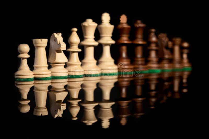 Premium Photo  Closeup of chess pieces on the chessboard under the lights  with a blurry background