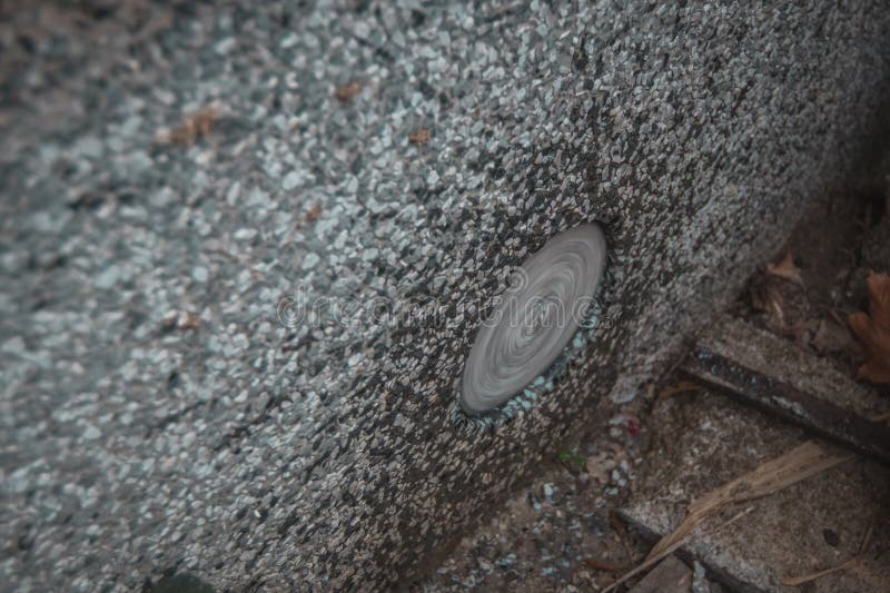 Diamant drill for making holes in the concrete exiting through drilled hole. Visible rotating drill and water royalty free stock image