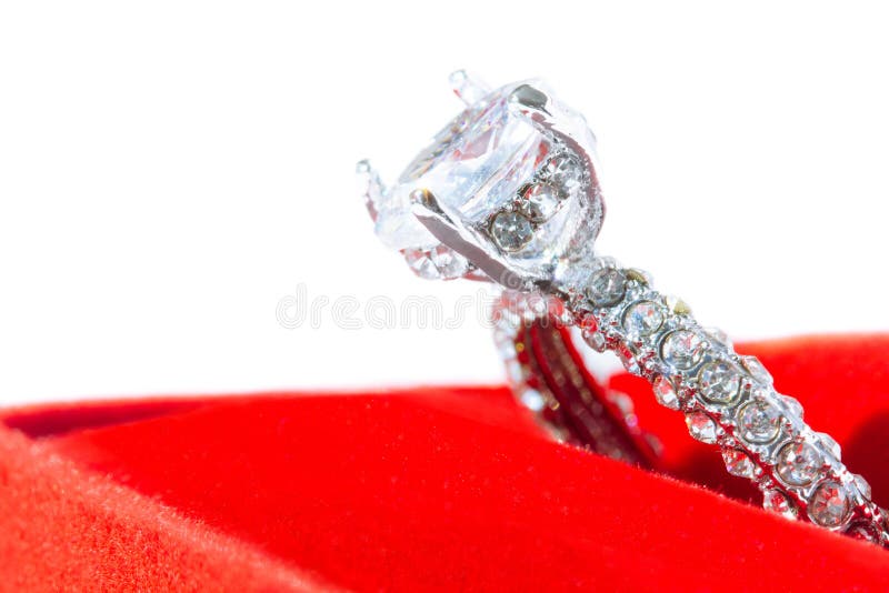 Diamond engagement ring in red box on white background