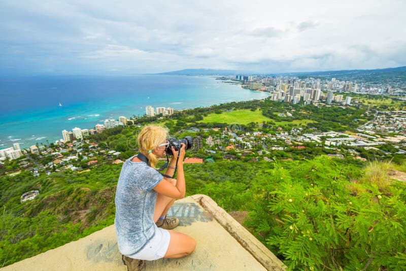 Travel photographer takes a shot of Honolulu and Waikiki beach, Oahu in Hawaii from Diamond Head State Monument. Nature photographer taking pictures outdoors during hawaiian hiking Diamond Head hike. Travel photographer takes a shot of Honolulu and Waikiki beach, Oahu in Hawaii from Diamond Head State Monument. Nature photographer taking pictures outdoors during hawaiian hiking Diamond Head hike.