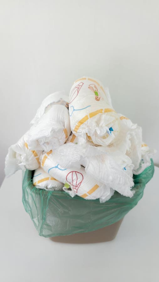 Diapers Waste: Overflowing trash bin filled with used baby diapers stock image