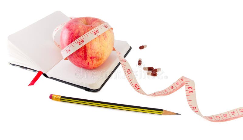 Diary with apple and pills for effective dieting