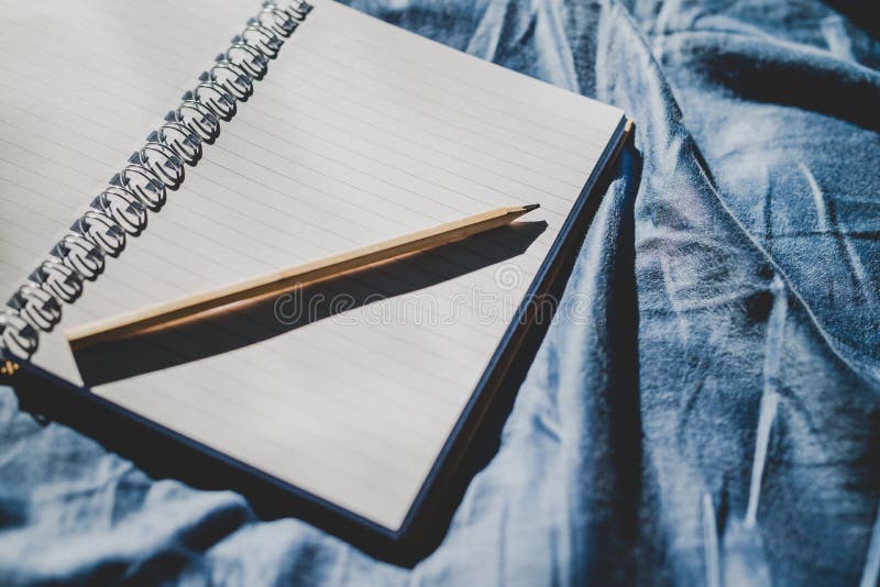 Diary notebook on blue bedding for journaling stock photo
