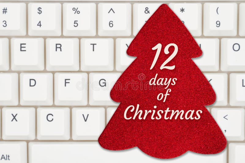 12 days of Christmas message on a red Christmas tree gift tag on a keyboard for your holiday online shopping message. 12 days of Christmas message on a red Christmas tree gift tag on a keyboard for your holiday online shopping message