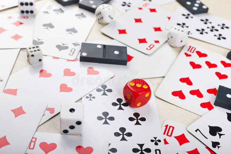 Playing Cards, Dominoes and Dice for Board Games on Table Close Up