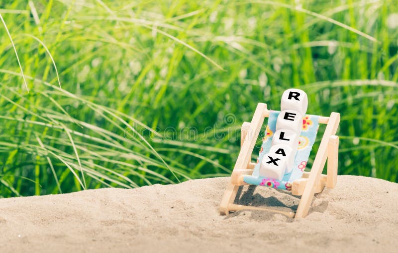 Dice Placed on a Beach Chair Form the Word Stock Image Image of