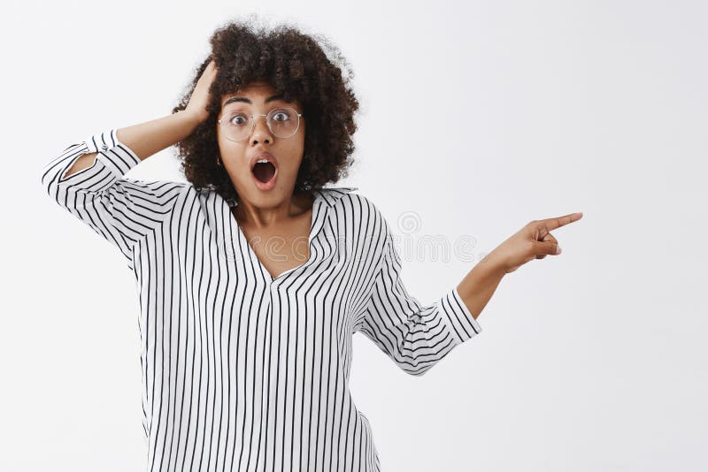 Did you just saw it. Portrait of shocked and speechless confused african american woman in glasses and striped blouse