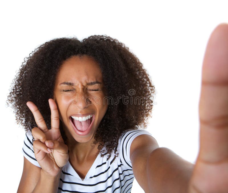 Close up self portrait of an excited young woman showing peace sign in selfie. Close up self portrait of an excited young woman showing peace sign in selfie